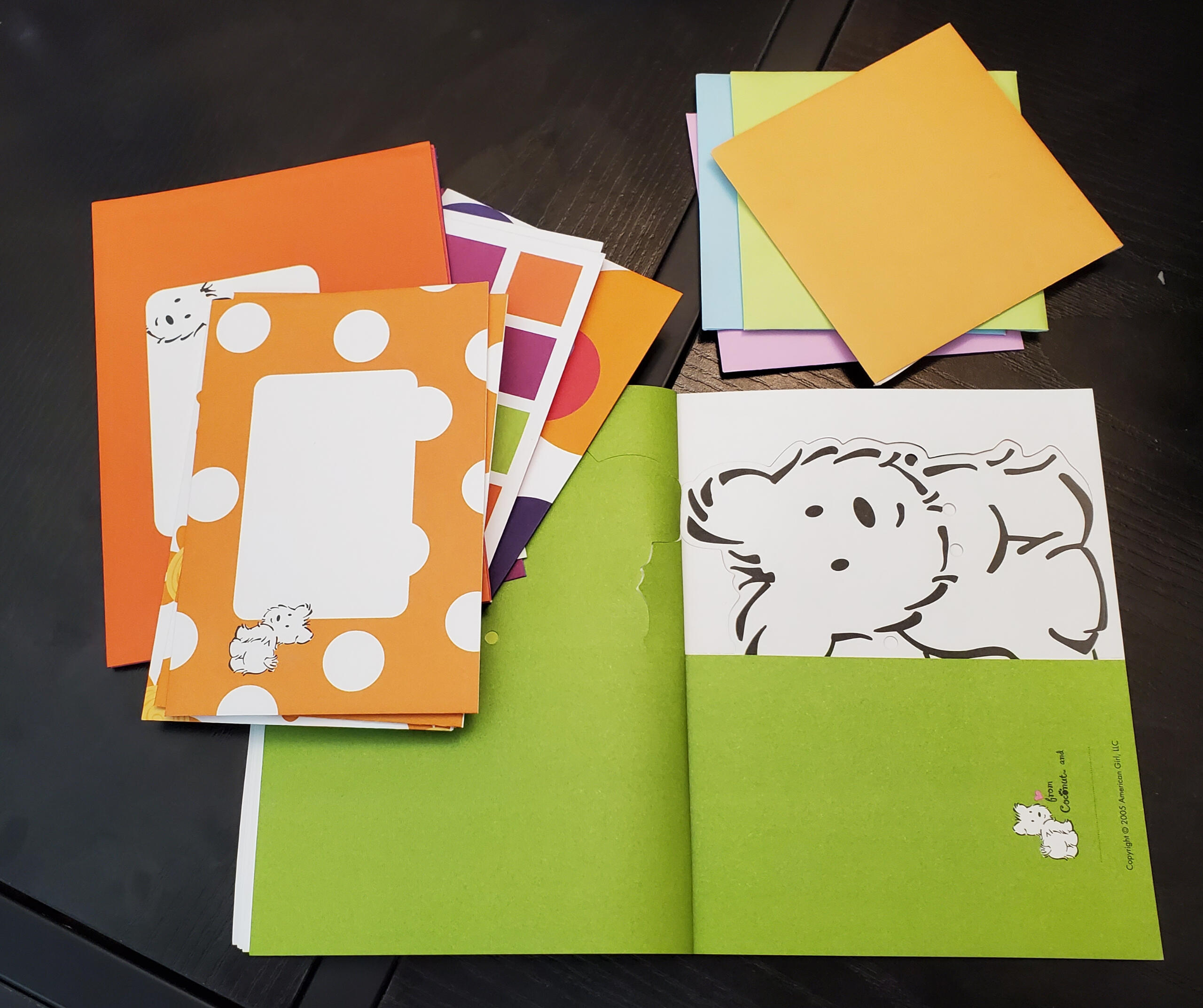 Image alt. text: photo of sophomore Alex on a lofted dorm room bed with a hot pink, black, and white bedspread. She is smiling and looks a little terrified.